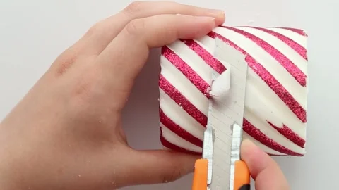 Slow, smooth cutting of a candle with a red pattern. Asmr. Part 1 Stock Footage 280605485
