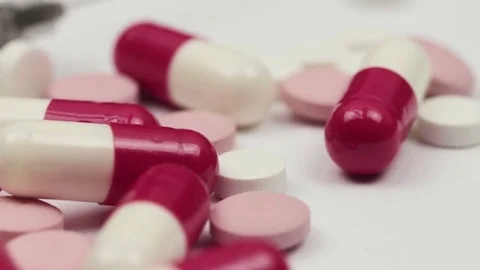 Slow smooth macro slide over different multicolored pills and a syringe Stock Footage 72404958
