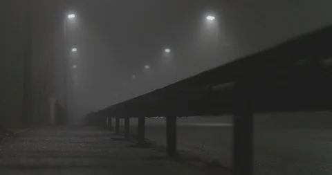 Slow smooth movement on an empty mysterious foggy city street at night Stock Footage 111345172