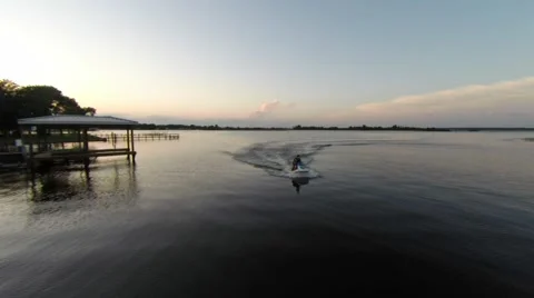 Slow speed jet ski at sunset Stockbeeldmateriaal 50446921