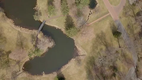 Slow spin Drone over small lake and trees 스톡 동영상 106059162