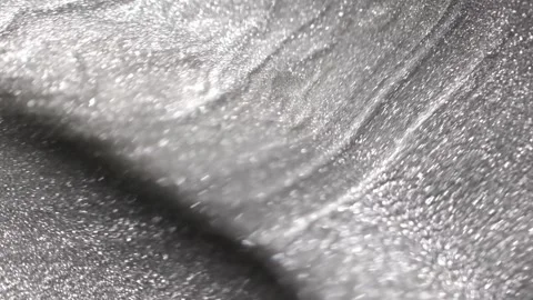 Slow spinning shot of dark silver paint specialized sandy texture and radiant Stock Footage 327604751