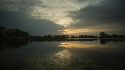 Slow Sunset Over Lake - Timelapse - 4K - 23.98 fps - England - UK Stock Footage 147491276