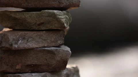 Slow Tilt Up Close Up View Of Stacked Rocks Near River 스톡 동영상 315225352