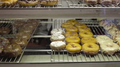 Slow tilt up of donuts in a bakery 스톡 동영상 60720891