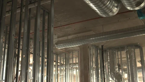 Slow Tilt Down From Ceiling Ducts to Metal Stud Framing Construction Site Vidéo 336321293