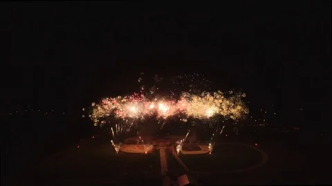 Slow tilt down with low fast fireworks center Stock Footage 90256498