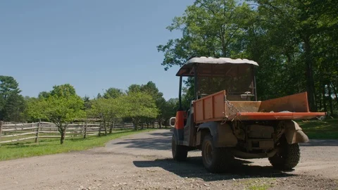 Slow tilt down reveals Utility Vehicle on dirt road in Idyllic Equestrian farm Stock Footage 117634949