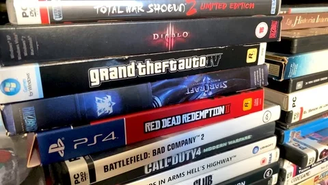 Slow tilt down shot of many pc and playstation videogames. Stock Footage 121055329