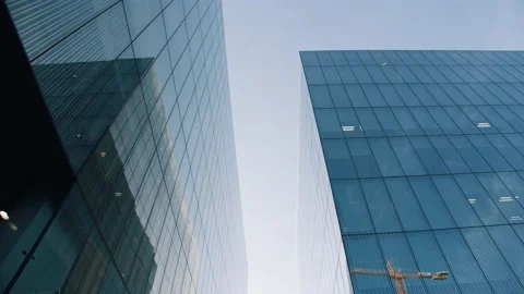Slow tilt-down shot of the reflections in an business center at dawn. Stock Footage 152021072