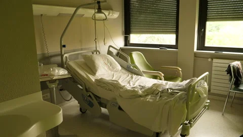 Slow tilt-up to the empty Hill-Rom bed of a patient inside a modern hospital Stock Footage 160361812