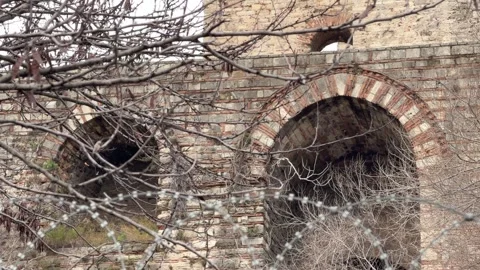 Slow tilt up shot weathered brick arches and stone battlements Stock Footage 340155071