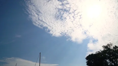 SLOW TILTE DOWN FROM MORING SKY TO LINE OF BAOTS IN HARBOR Stock Footage 106134554