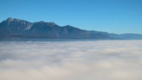 Slow time lapse of inversion clouds moving in alpine valley Stock Footage 172574685
