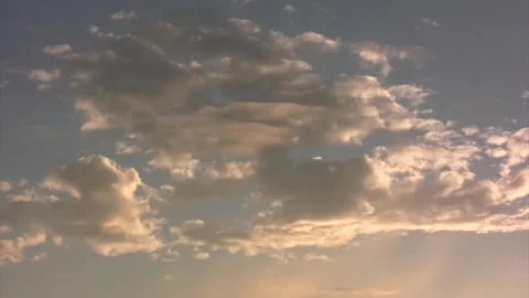 Slow timelapse clouds with warm highlights in blue sky Stock Footage 268254455