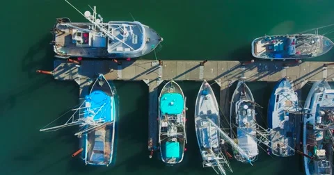 Slow top-down pan shot of boats at a dock in Newport, OR Stock Footage 67647551