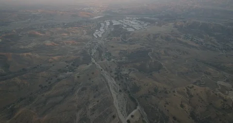 Slow tracking aerial over low buildings, day Stock-Footage 103361402