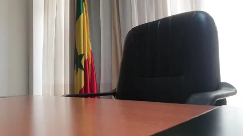 Slow Tracking foward Shot of Empty Office with Senegal Flag Stock Footage 294204238