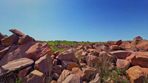 Slow Tracking Shot Across Sandstone Boulder Field Under Clear Blue Sky Stock Footage 340183485