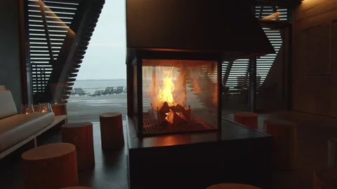 Slow tracking shot around a roaring fire in the middle of an empty room Stock Footage 146289211