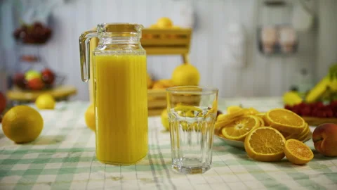 Slow tracking shot of beautiful orange juice display on kitchen counter Stock Footage 341243716