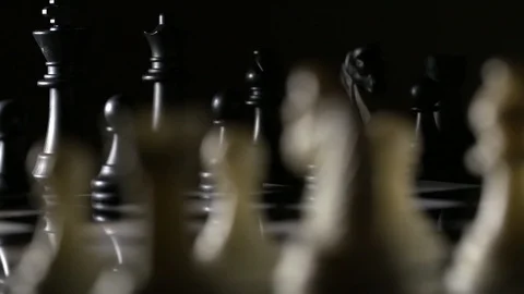 Slow tracking shot behind chess pieces on marble chess board Stock Footage 92525475