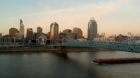 Slow tracking shot of Cincinnati skyline with freight moving along river Stock Footage 100416542