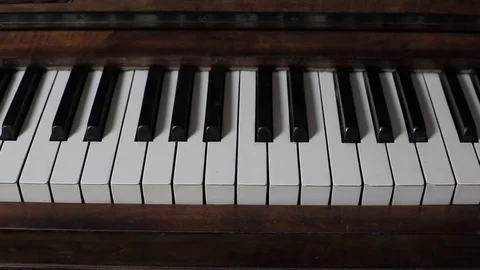 Slow tracking shot over piano keys, wooden upright Stock Footage 81111559