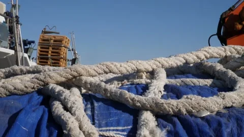 Slow tracking shot over the ropes in a fishing port. Stock Footage 138208777