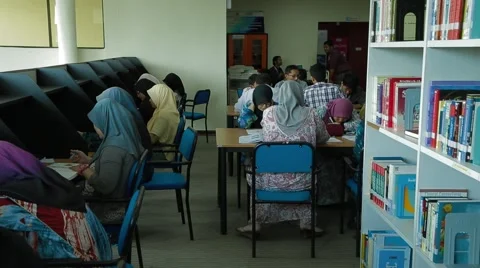 Slow Tracking Shot of Students Sitting and Studying in Allianze Library Stock Footage 49388039