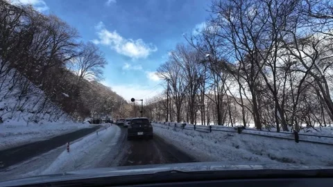 Slow traffic passing overturned car on snowy road in Hokkaido Video stock 333091448