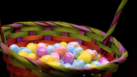 Slow trickle of easter eggs falling in a basket Stock Footage 87690721