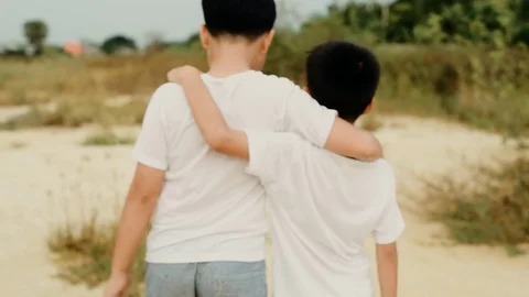 Slow two boy walk on the dry land Stock Footage 82447815