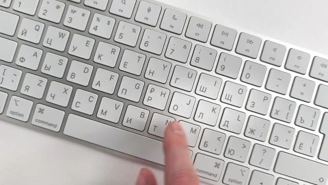 Slow typing on keyboard with a single finger carefully selecting letters on.. Video stock 345552791