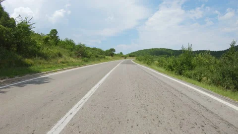Slow uphill drive of a car or motorcycle on a bumpy winding mountain road Stock Footage 233335772