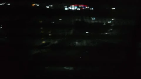 Slow upward scan: abstract grid patterns over blurred metropolis light Stock Footage 305882569