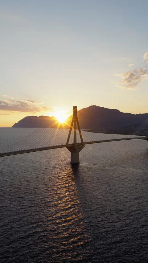 Slow vertical panning drone shot of Rio-Antirrio Bridge during sunset, near Stock Footage 341935285