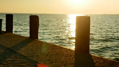 Slow walk next to the dock in the sunset on lake Balaton / HU water 스톡 동영상 116102803