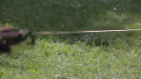 Slow walking of bare feet on stretched slackline and subsequent jump Stock Footage 83588678