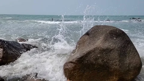 Slow Wave crashing rocks 2 Stock Footage 239409128