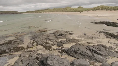 Slow waves arrive on the beach 4K- Scotland Durness Stock Footage 94869351