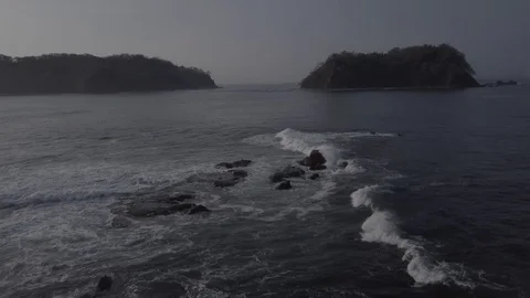 SLOW WAVES ROLLING OVER ROCKS | PART 05 OF 05 | EXT, MEDIUM, CIRCLING | 2398 |4K Stock Footage 105256235