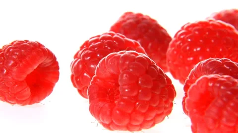 Slow zoom and pan over raspberries on white surface Stock Footage 46585521
