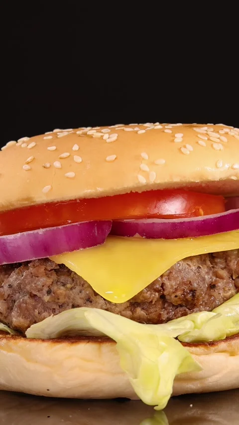 Slow Zoom-In on Classic Cheeseburger with Fresh Toppings Stock Footage 314928371