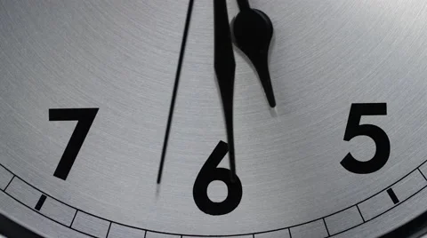 Slow zoom into a clock face as time counts down to 5:30 Stock Footage 60828488
