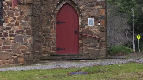 Slow zoom on an old red door of a medieval stone church Stock Footage 341903967