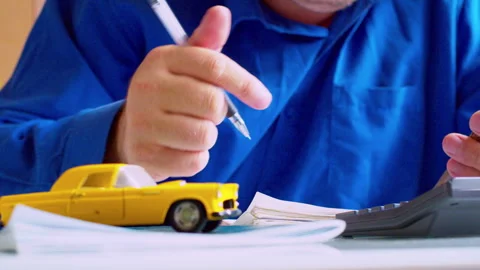 Slow zoom out. Agent hands using calculator and holding smartphone Stock Footage 337669267