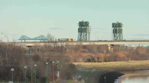 Slow zoom out from iconic bridges over River Tees to White Water Course Stock Footage 1059573