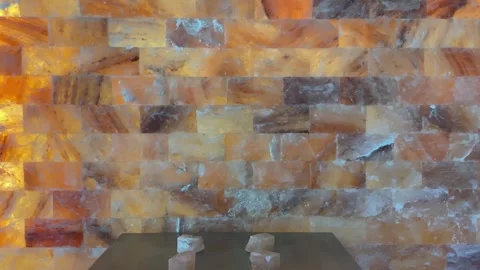 Slow zoom out of lit himalayan salt wall in spa room. Stock Footage 345809387