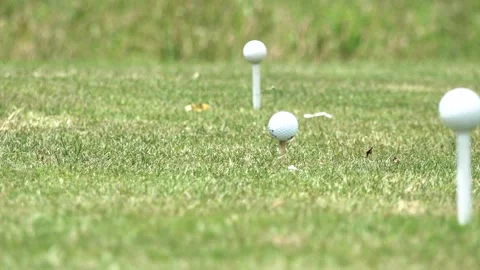 Slow Zoom Out of Three Golf Balls Placed on White Tees Stock Footage 337656938